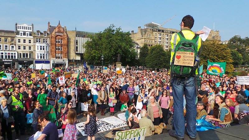 Person speaking to climate march crowd